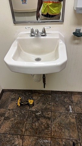 Bathroom sink and chrome faucet serviced by our plumber